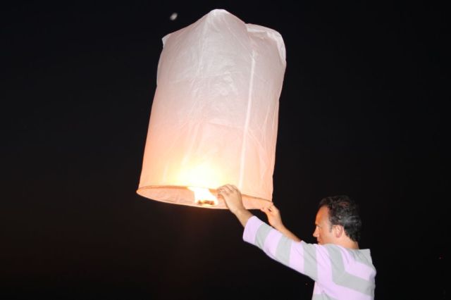 Letting up a lantern on the beach at night